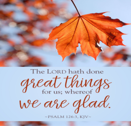 A dark orange fall leaf against a blue sky. Below it we see the words of Psalm 126:3— "The Lord has done great things for us, and we are filled with joy."